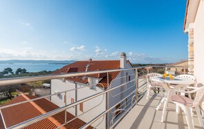 A balcony with a view of the sea, a table with chairs, and a railing. - Beautiful apartment in Sveti Filip i Jakov (Sveti Filip i Jakov)