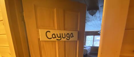 A wooden door with a sign reading "Cayuga."