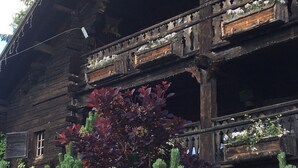 A rustic wooden building with a balcony and a window. - Authentic, warm, luxurious chalet, swimming pool, jacuzzi, sauna and fireplace (Les Contamines-Montjoie)