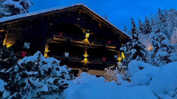 A log cabin with a balcony, surrounded by snow-covered trees. - Authentic, warm, luxurious chalet, swimming pool, jacuzzi, sauna and fireplace (Les Contamines-Montjoie)
