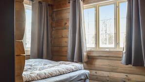 A room with a bed, wooden walls, and a window with curtains. - Pet friendly home in Hovden I Setesdal (Hovden I Setesdal)