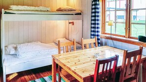 A bunk bed with a pillow and a small table with chairs. - Cozy home in Sysslebäck with WiFi (Sysslebäck)