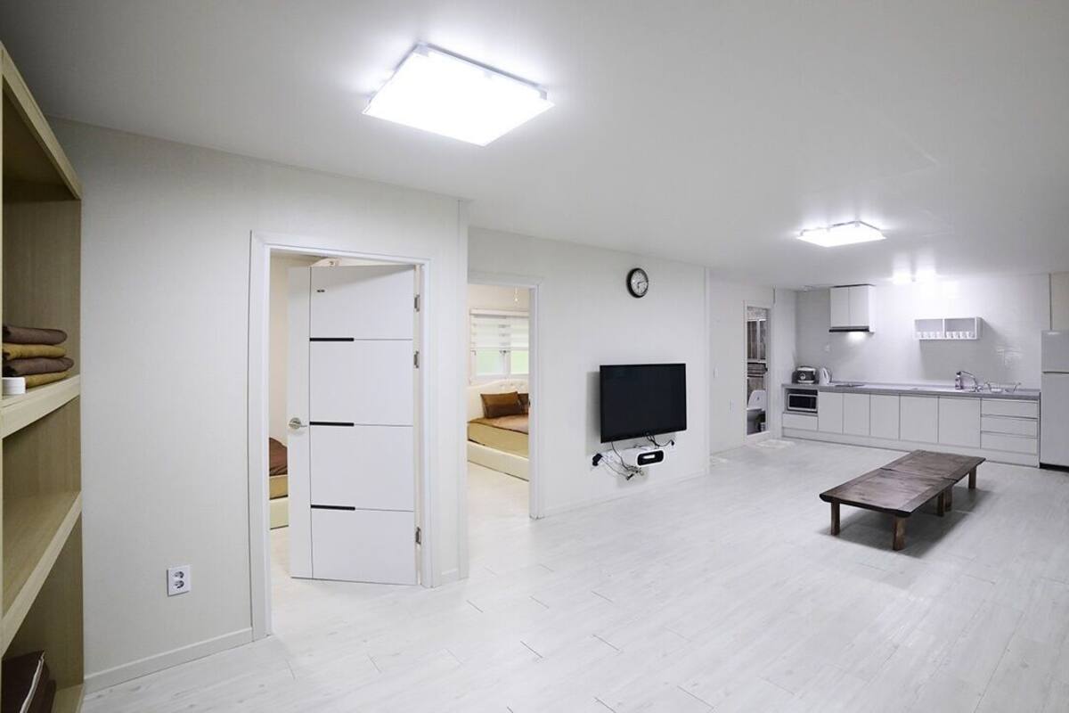 A modern apartment with a living area, kitchen, and dining space.