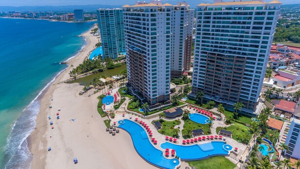 A resort with beachfront, high-rise buildings, and a swimming pool area. - Grand Venetian Puerto Vallarta Beachfront Condo  (Puerto Vallarta)