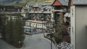 Et boligområde med etagebyggeri, en asfalteret vej og et bjerg i baggrunden.