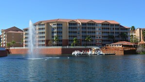 A hotel with a water fountain, a swan, and boats. - Amazing Studio @Town Center Resort  (Kissimmee)