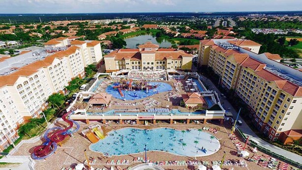 A resort with multiple buildings, a central pool area, and a water park. - Amazing Studio @Town Center Resort  (Kissimmee)