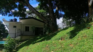 A residential house with a sloped roof, a satellite dish, and a small balcony. - Signature Kandy (Kandy)