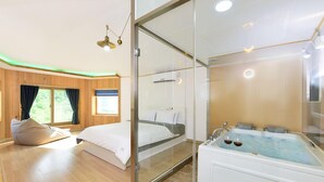 A modern bedroom with a glass shower enclosure, a separate sleeping area, and a large bathtub with two glasses of wine. - Camel Pension (Gapyeong)