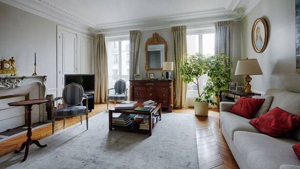 A spacious living room with a sofa, a coffee table, a television, a fireplace, and a large window with curtains. - Suburban Peace in Neuilly-Sur-Seine, by Veeve (Paris)