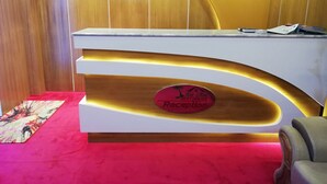 A reception desk with a sign that reads "Rich Mall Rest House Reception". - Richmart Resthouse (Barisal)