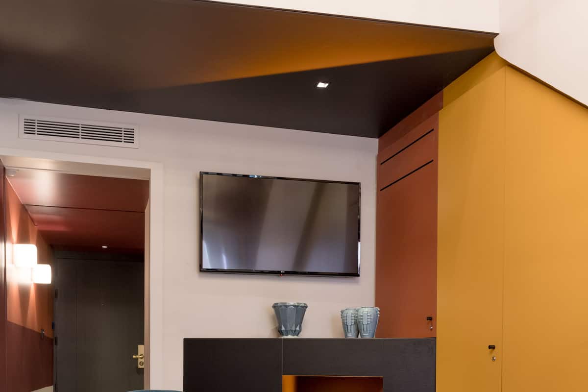 A modern living room with a blue armchair, a small round table, and a fireplace.