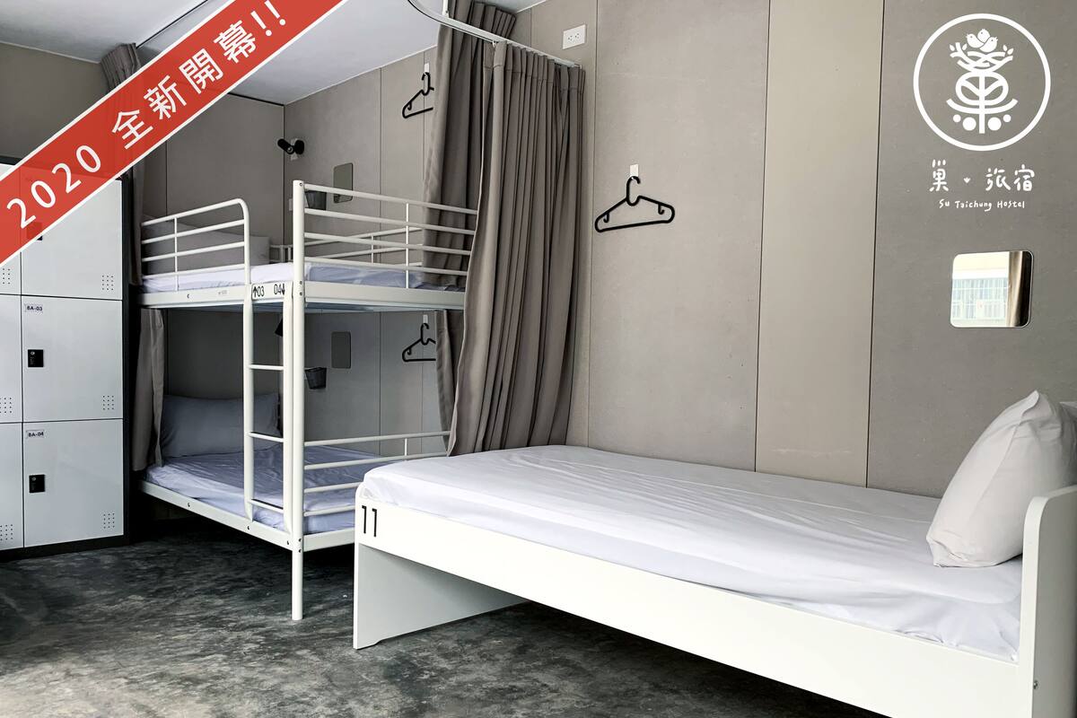 A bunk bed room with a single bed, a wardrobe, and a wall-mounted hanger.
