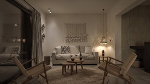 A modern living room with a sofa, two wooden chairs, a coffee table, and a large window with curtains. - Bianco Villa - Eve (Rhodes)