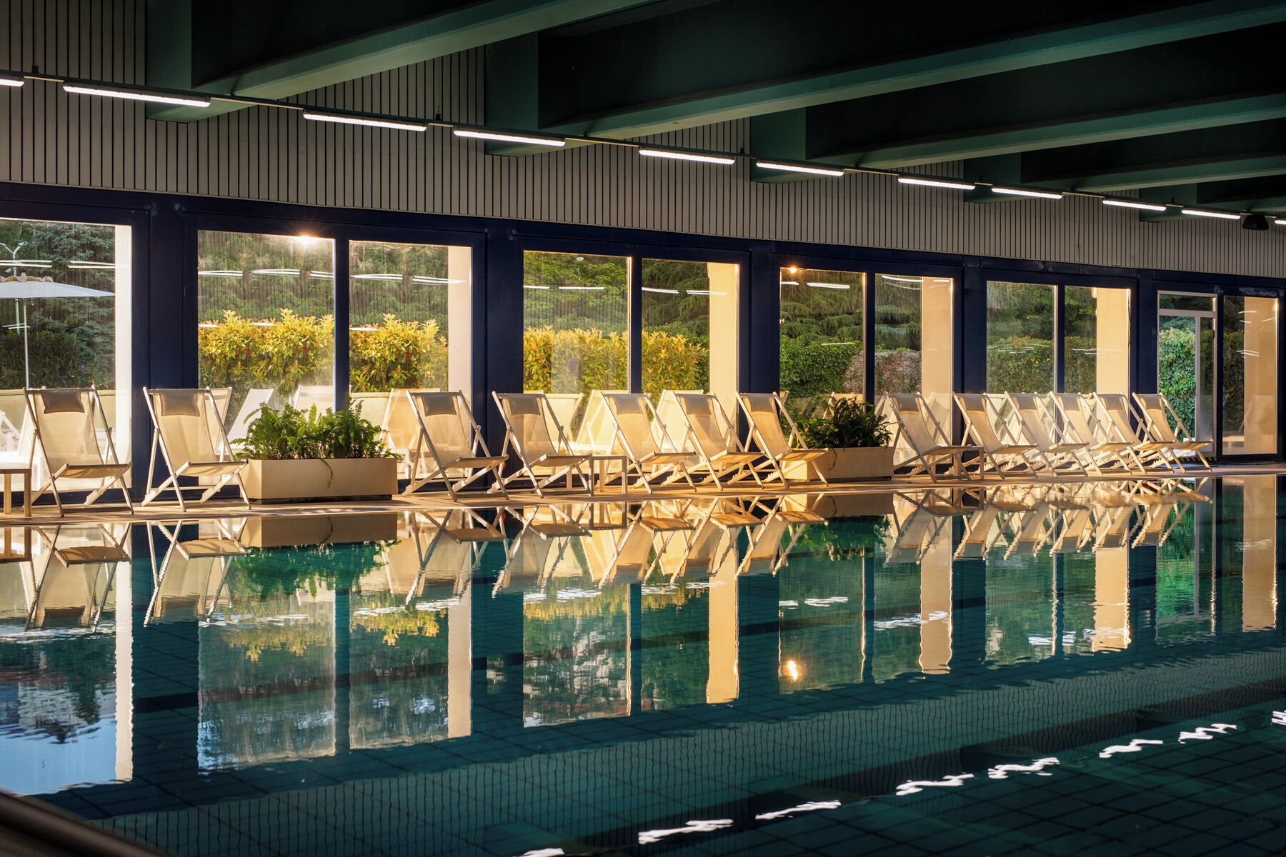 Indoor pool, outdoor pool, pool umbrellas, pool loungers