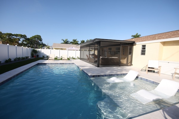 Salt water pool and large covered lanai in fully fenced backyard.