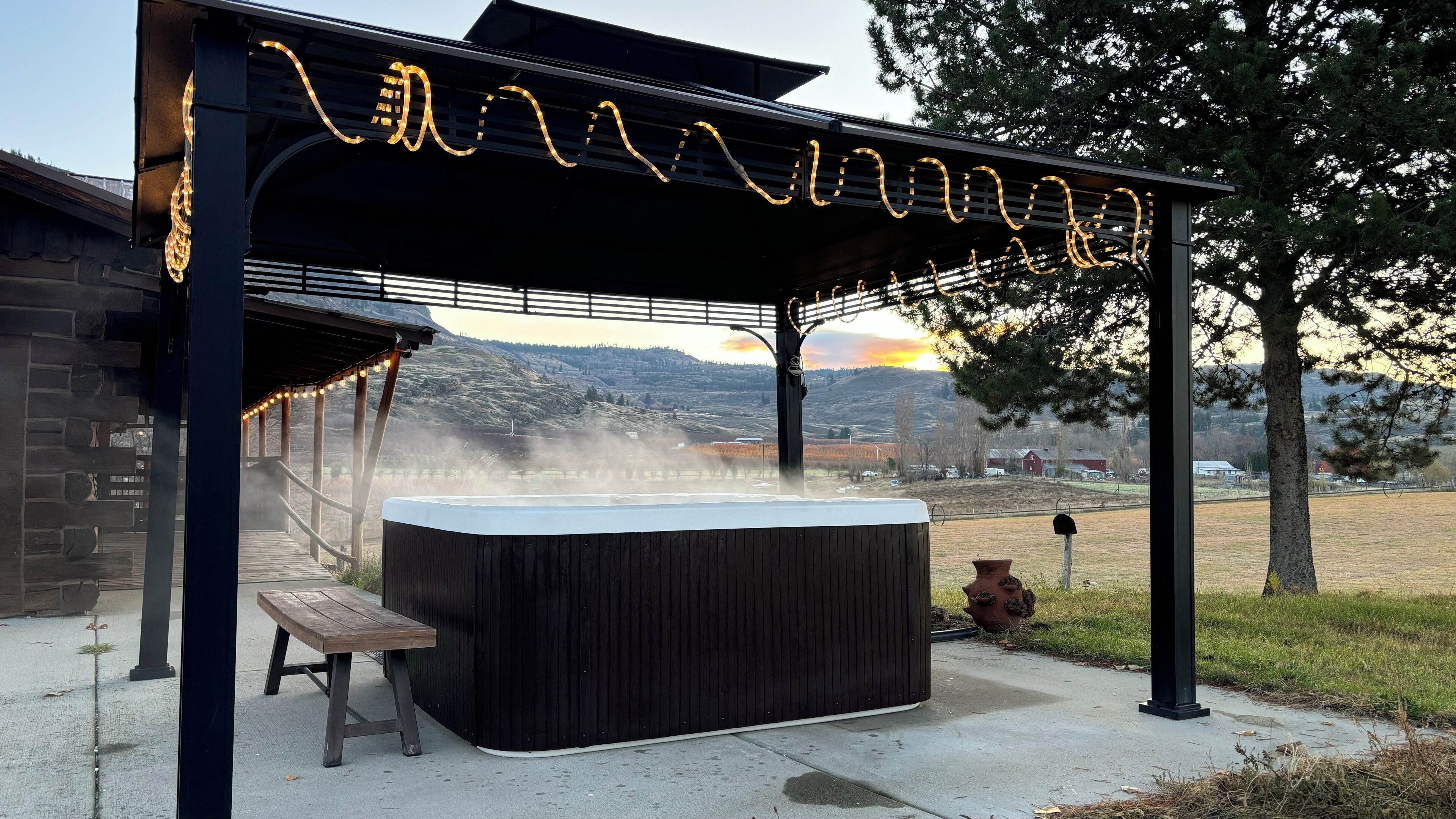 Soak in the hot tub with stunning valley and mountain views under the gazebo.