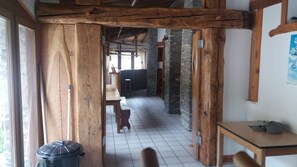 Experience a traditional setting with a long hallway leading to a dining area and a tiled floor.