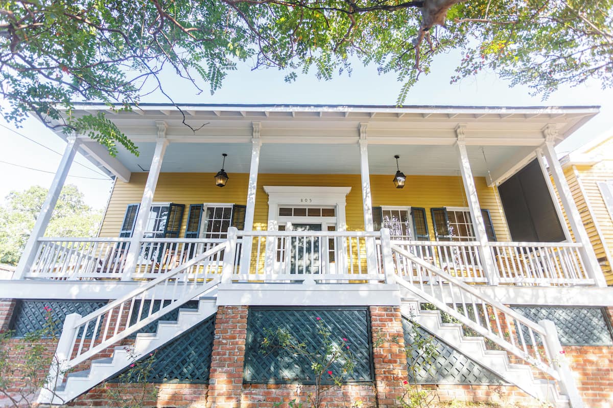 A two-story building with a porch, a staircase, and a door marked '805'.