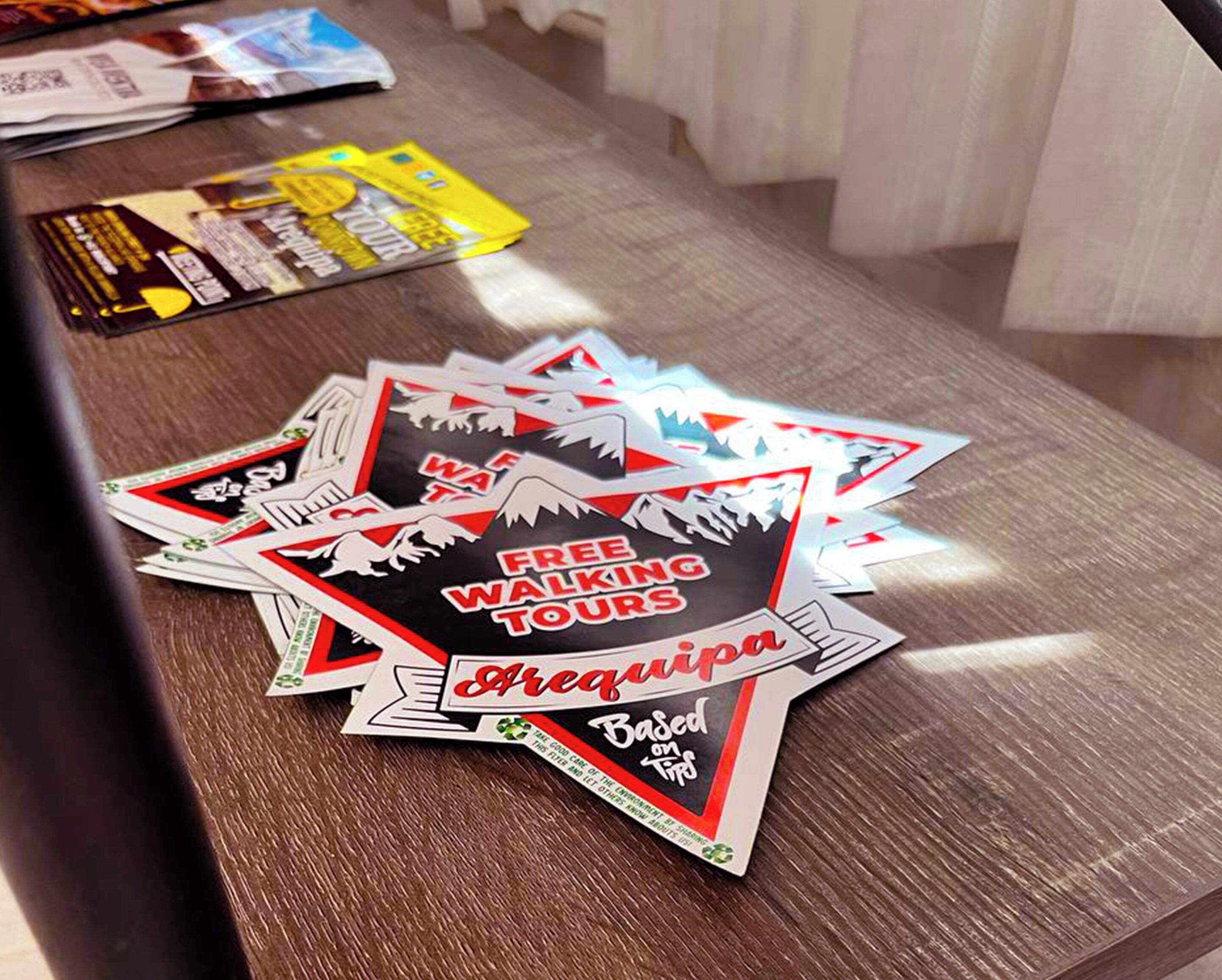 A table with various promotional materials, including flyers and brochures.