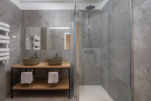 A modern bathroom with two vessel sinks, a glass shower enclosure, and a large mirror. - Sun Dance Luxury Villa I (Primošten)