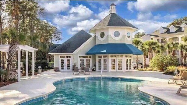 A large house with a swimming pool, a gazebo, and a covered patio area. - Pretty Peony Steps to Pool - Myrtle Beach, SC (Myrtle Beach)