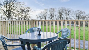 A wooden deck with a round table and four chairs. - 1 bedroom accommodation in Brocklebank, near Caldbeck and Uldale (Brocklebank, near Caldbeck and Uldale)