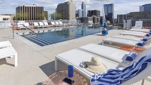 A rooftop pool area with lounge chairs and a view of the city skyline. - Prime Austin 2 BR downtown new location (Austin)