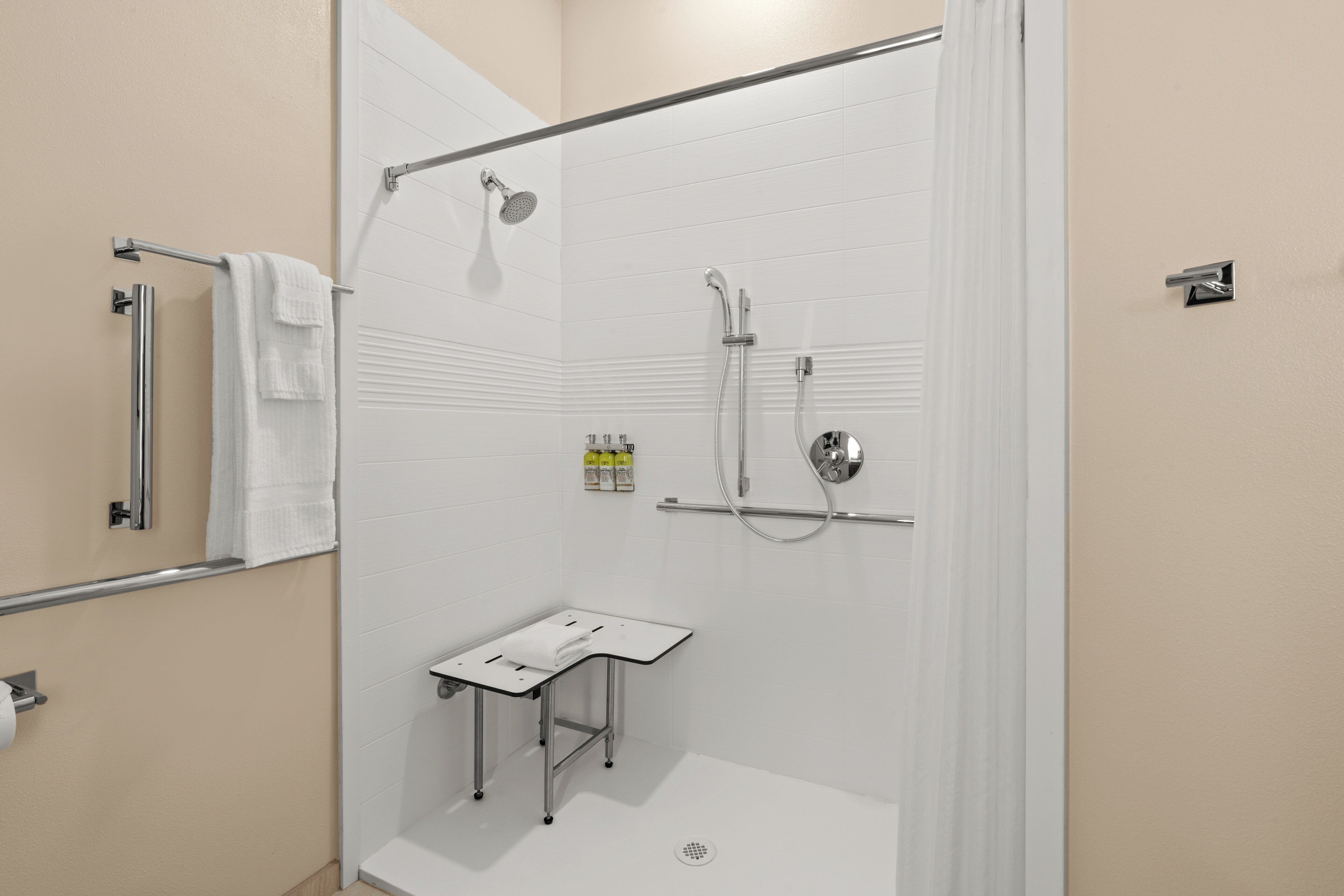 studio suite, 1 king bed, roll-in shower (mobility) | bathroom | separate bathtub and shower, towels