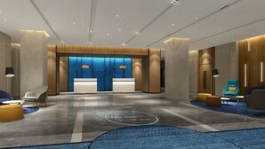 A modern lobby with a reception desk, seating area, and a blue patterned wall. - Holiday Inn Express Huaibei City Center by IHG (Huaibei)