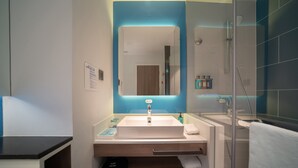 A modern bathroom with a large mirror, a sink, a shower, and a towel rack. - Holiday Inn Express Huaibei City Center by IHG (Huaibei)