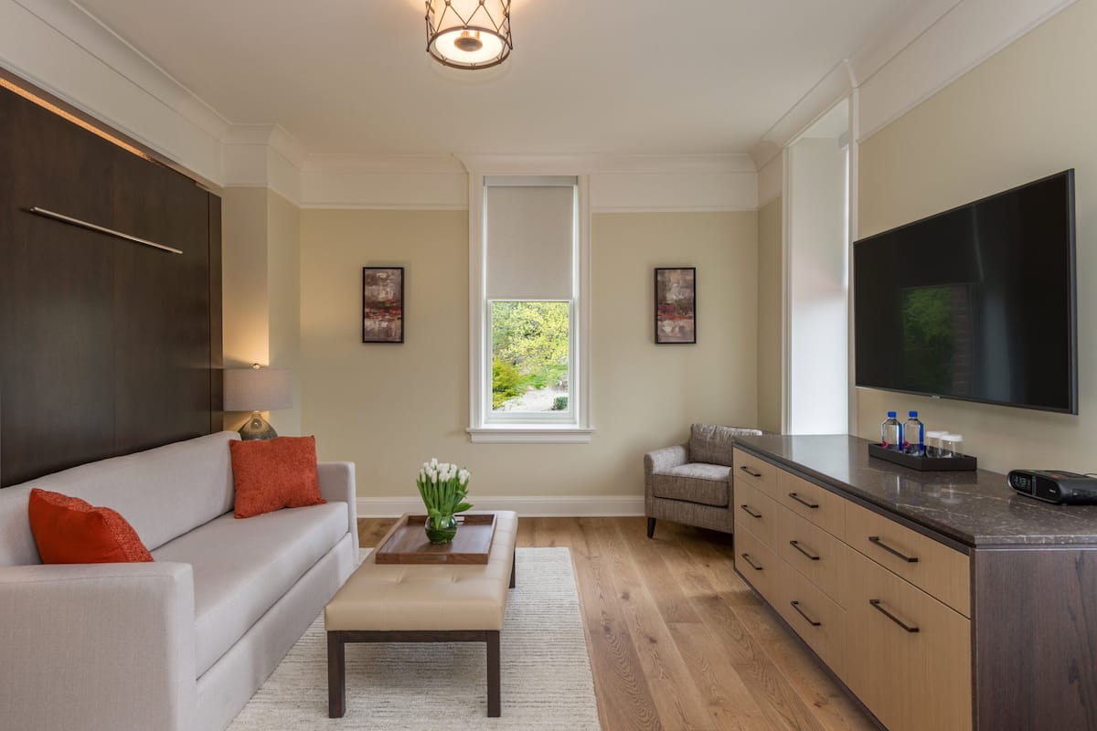A modern living room with a sofa, coffee table, and a television.