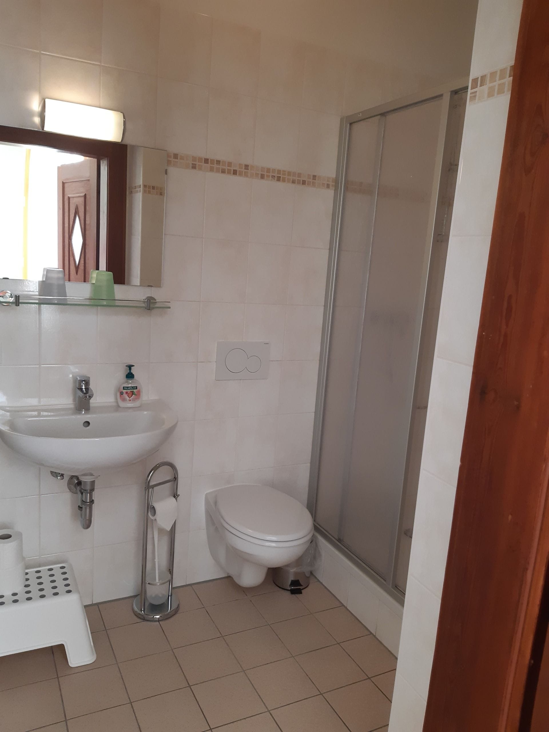 A bathroom with a sink, toilet, and shower.