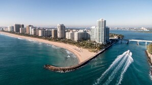 A coastal cityscape with high-rise buildings, a beach, and a bridge. - Privately managed 2BR+ 2,5Bath  best line oceanfront at the Ritz  Bal Harbour  (Bal Harbour)
