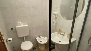 Ein Badezimmer mit Toilette, Bidet und Waschbecken.