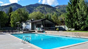 A swimming pool with a view of mountains in the background. - RMR: Tensleep A5 Condo in Teton Village (Teton Village)