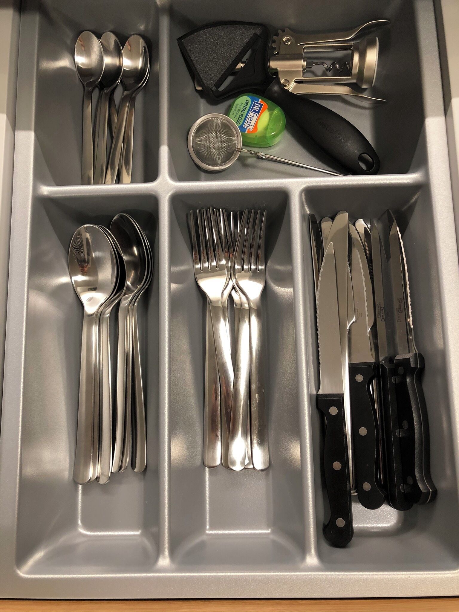 A kitchen drawer with utensils and appliances.