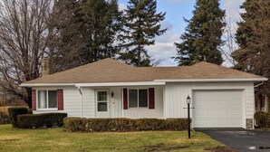 A single-story house with a garage, a front lawn, and a driveway.