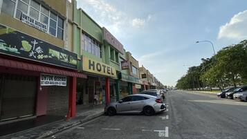 A street view with a hotel, a restaurant, and a pharmacy.