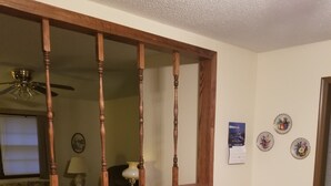 A dining area with a wooden table, two chairs, a decorative bowl, and a mirror above the table. - Grandma's house in the heart of Goddard (Goddard)