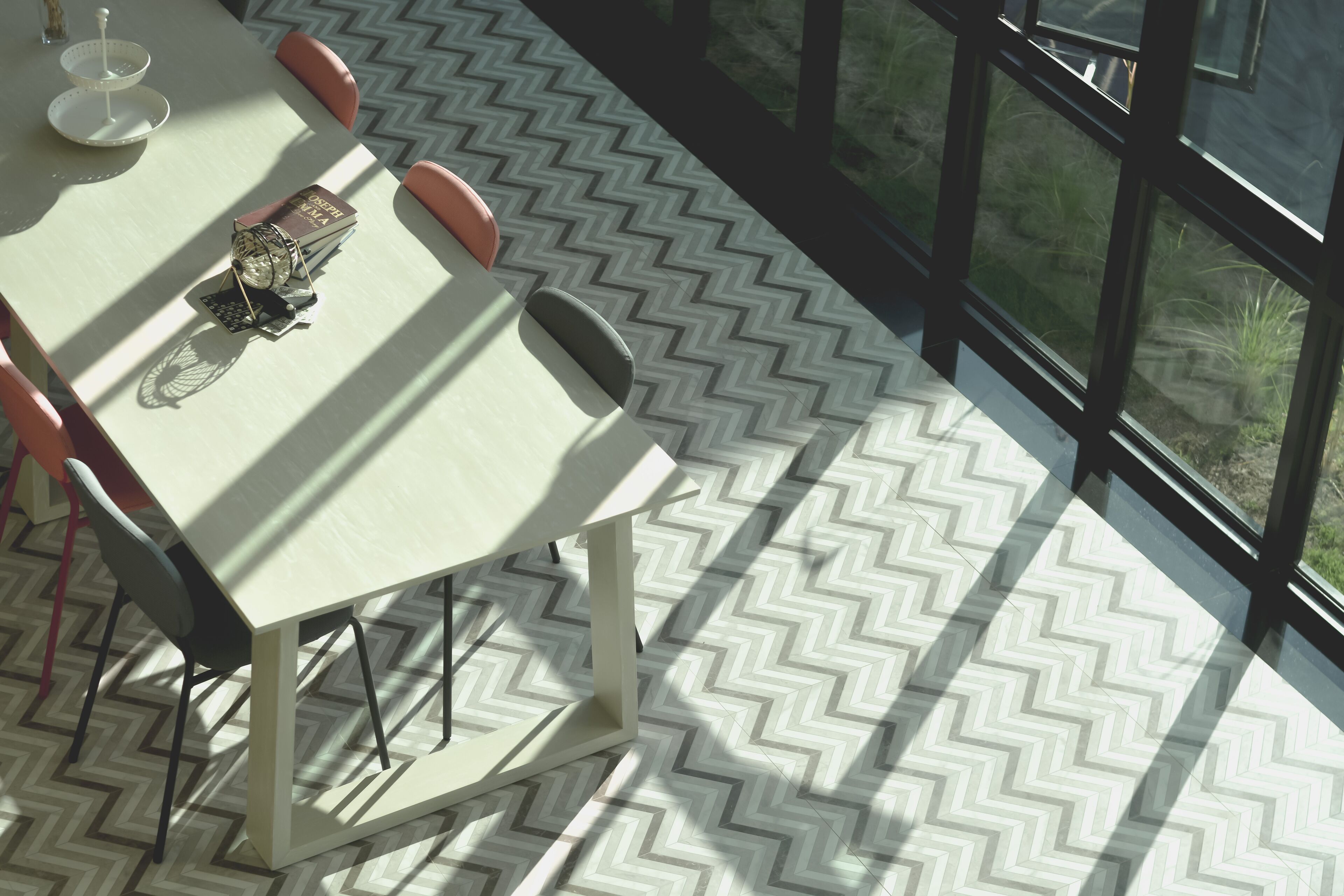 A modern dining area with a table, chairs, and a decorative centerpiece.
