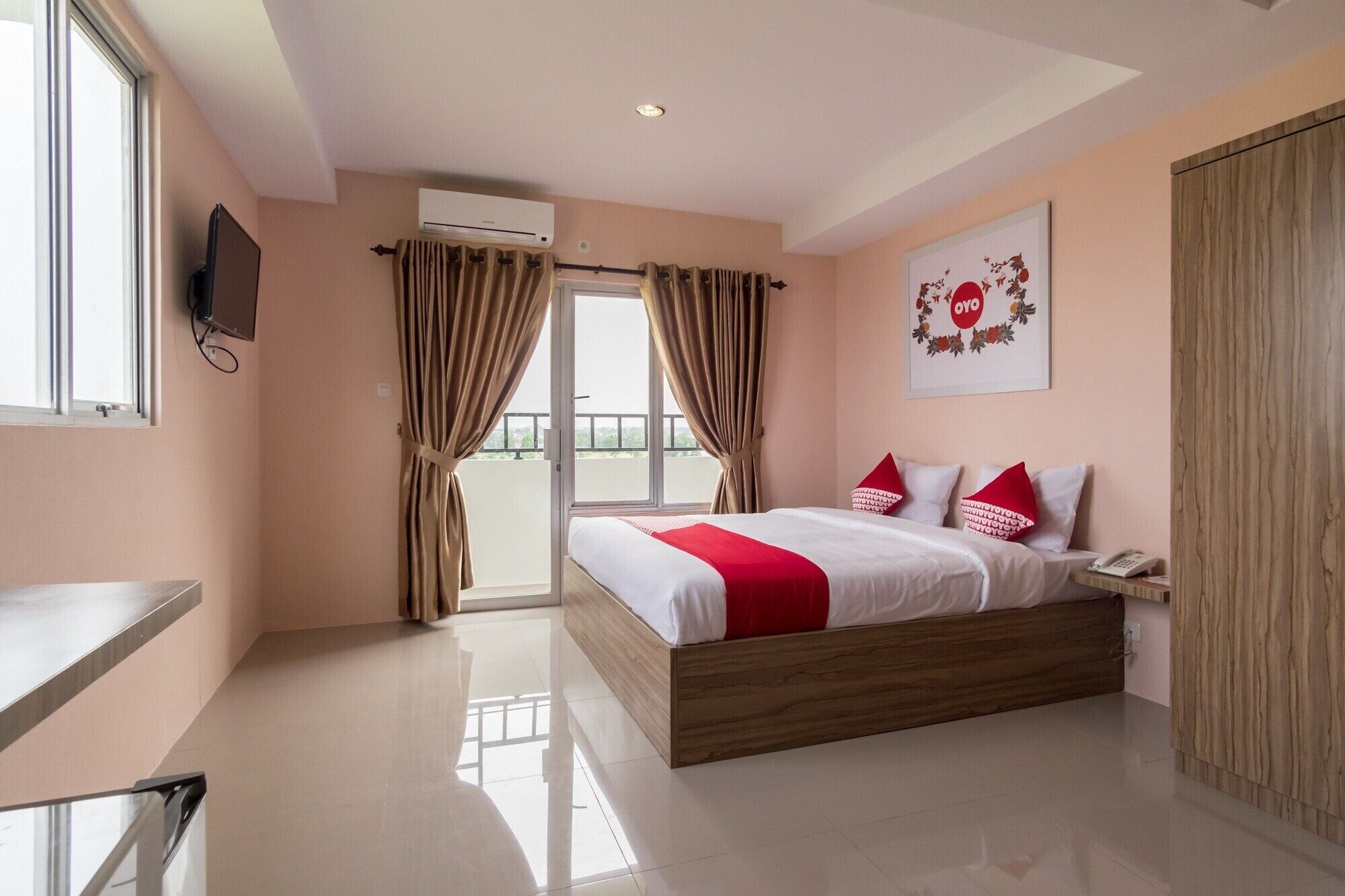 A hotel room with a large bed, a desk, a phone, and a view of the outdoors.