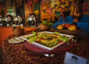 A table with a green salad, a plate, and a sign indicating 'GREEN SALAD'. - The Udai Bagh (Mavli)
