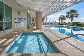 Relax by the pool surrounded by a shaded pergola and enjoy the hotel's facilities nearby.