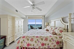 Relax in this serene space with a large bed, wardrobe, and ocean views through the sliding glass door.