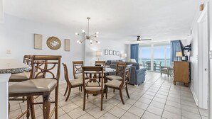 A spacious living area with a dining set, a sofa, and a view of the ocean. - Spacious 3 bedroom unit in Bluewater Keyes | Bluewater Keyes - 1105 (North Myrtle Beach)