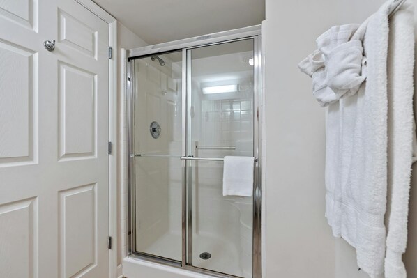 A glass-enclosed shower with a white towel hanging on the wall. - Luxurious 2 bedroom home away from home! | Blue Water Keyes - 1201 (North Myrtle Beach)