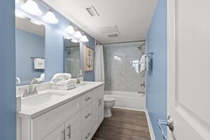 A modern bathroom with a double sink vanity, a shower, and a toilet. - Bright beautiful 2 bedroom condo on the beach! | Crescent Keyes -  703 (North Myrtle Beach)