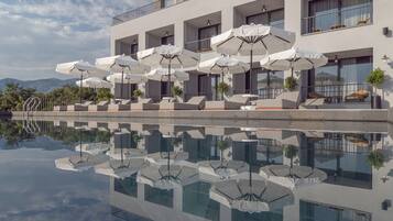 Seasonal outdoor pool, open 9:00 AM to 6:00 PM, pool umbrellas