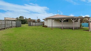 A single-story house with a gabled roof, a fenced backyard, and a small shed. - Southern Tides - an ideal getaway for the whole family (Port Fairy)